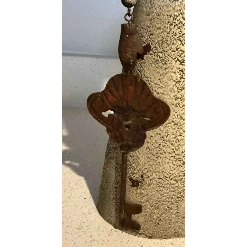 VTG decorative rustic metal sculpture of a stylized figure holding a large key.